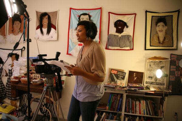 A photograph of Lauren Cross directing a documentary.