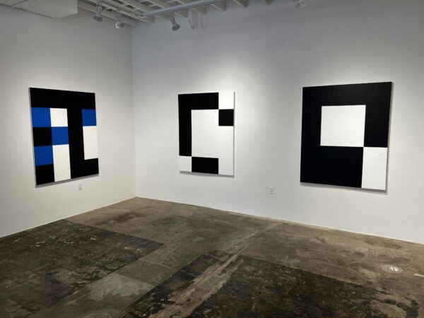 Large geometric works in blue and black