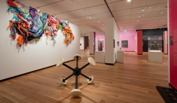 An installation image featuring sculptures and framed works in a gallery.