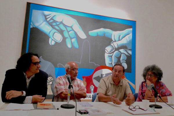 Photo of four people sitting on a panel