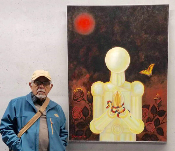 Photo of the artist with a painting