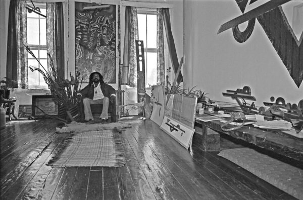 Photo of the artist Ellsworth Ausby sitting in his studio