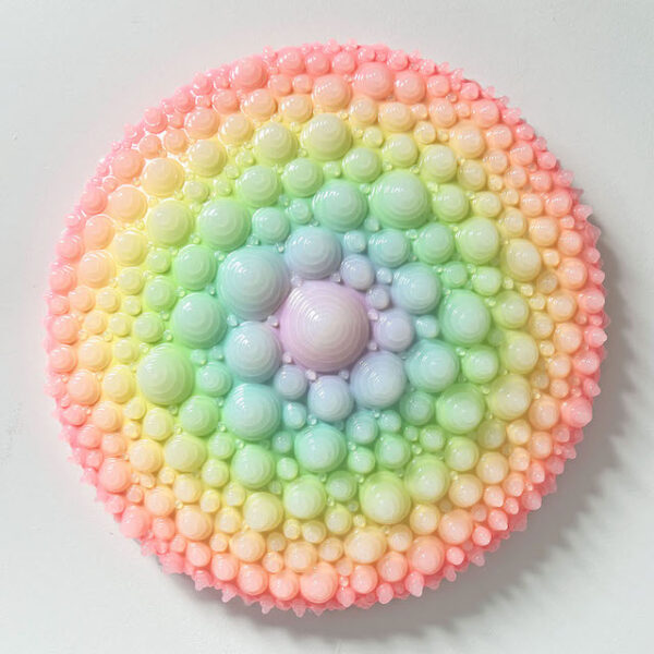 A photograph of a rainbow-colored round sculpture by Dan Lam.
