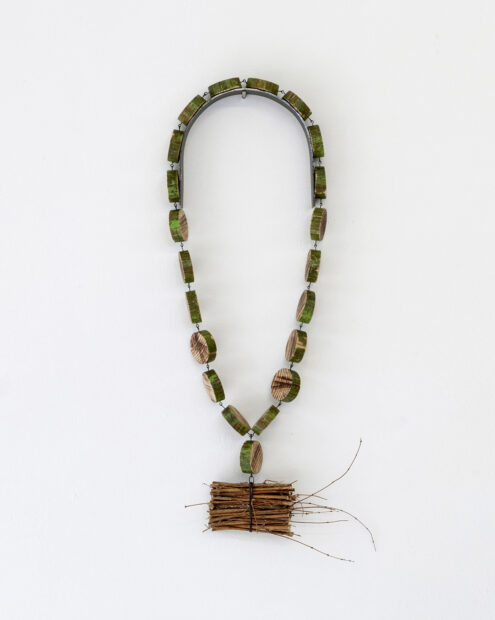 Pendant necklace made from a broom