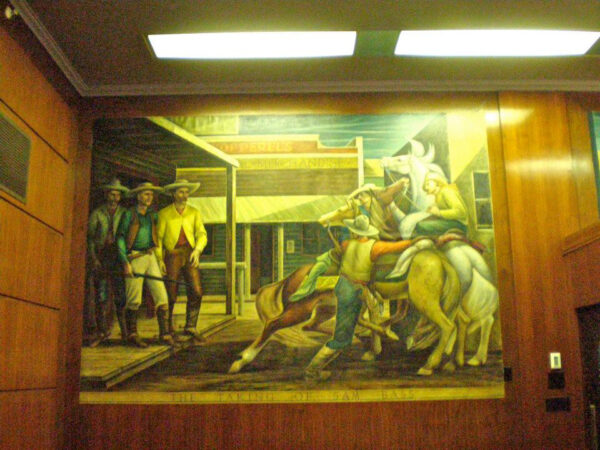 A cowboy calming a group of horses in a mural
