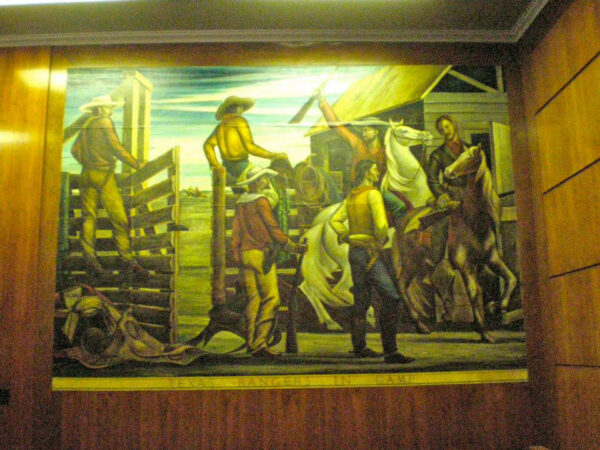 A scene of cowboys and horses painted on a mural