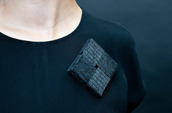 Image of a square brooch made of staples