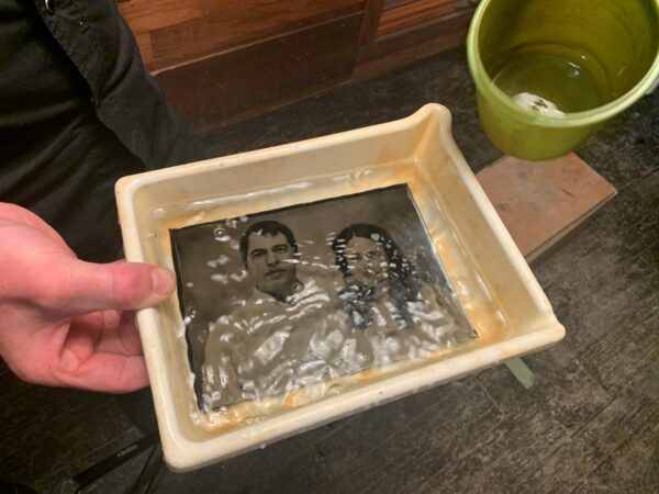 Tintype in a chemical tray bath being produced