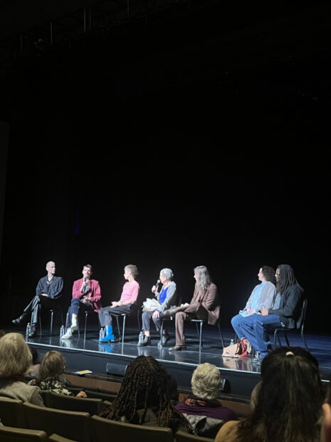 People onstage in a panel discussion