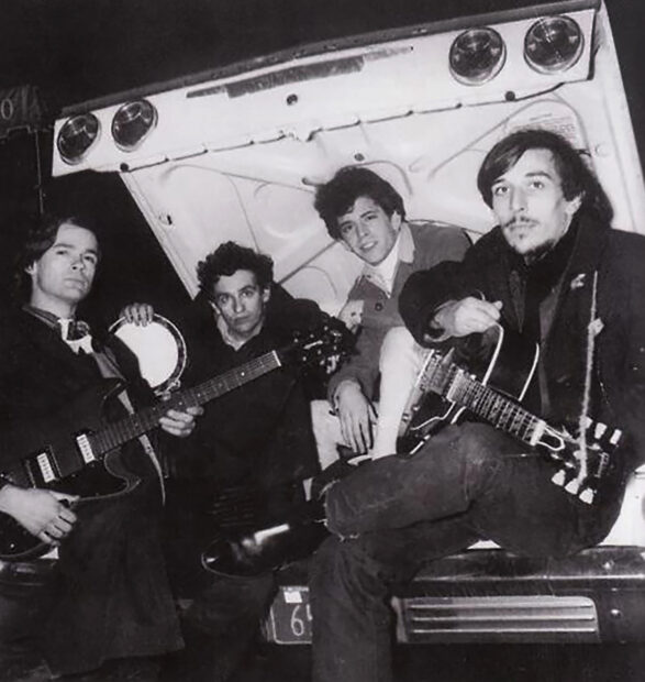 The Primitives band posing in the trunk of a car