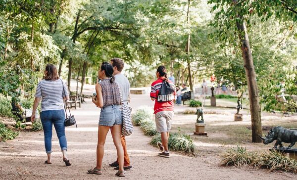 A photograph of people walking through the UMLAUF sculpture garden in Austin.
