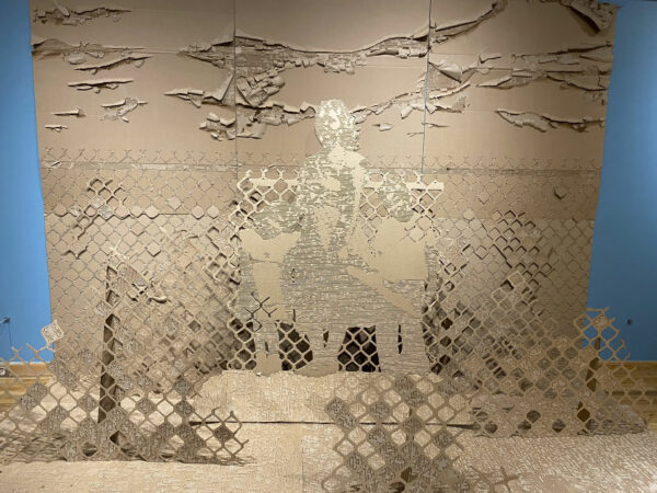 Installation of a landscape with a figure cut from cardboard