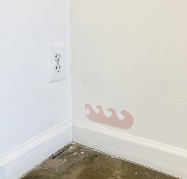Drawing of small pink waves above a baseboard