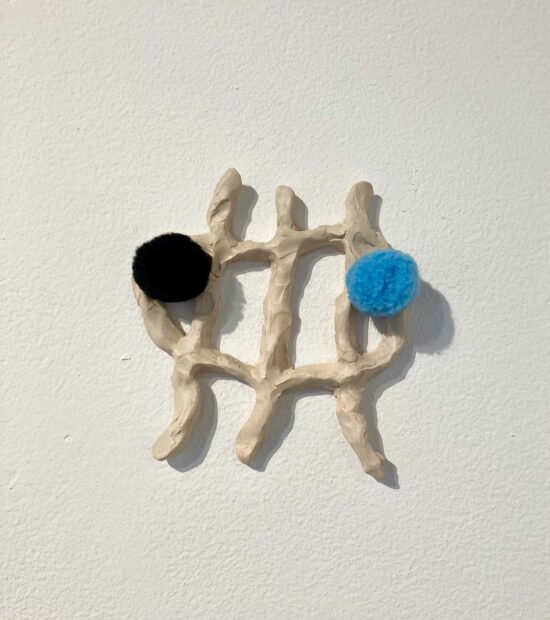 wall sculpture of an abstract form with black and blue dots