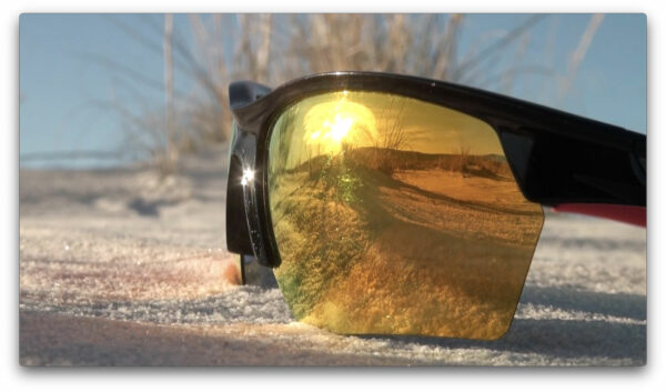 Video still of sunglasses on the ground in the desert