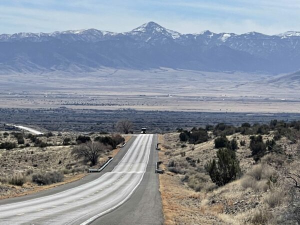 Photo of the open road with a mountain in the backgrouond