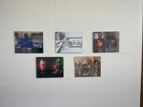Five photos on a wall in two rows