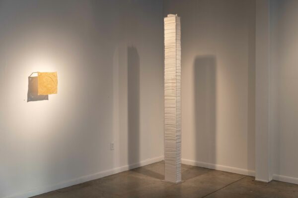 Installation view of a tissue tower and a work on the wall