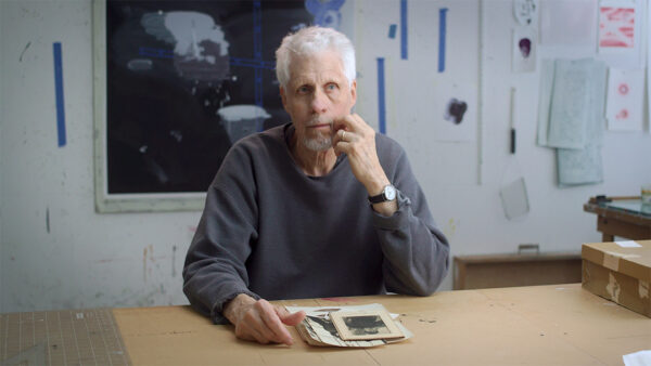 A still image of artist Vernon Fisher from Michael Flanagan's "Breaking the Code."