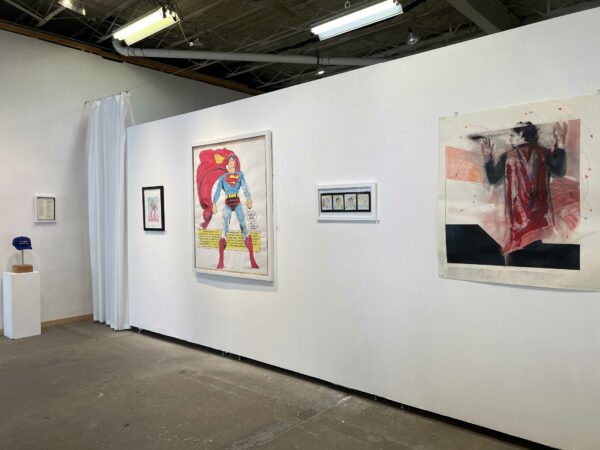 Installation shot of two dimensional works hanging on a white wall