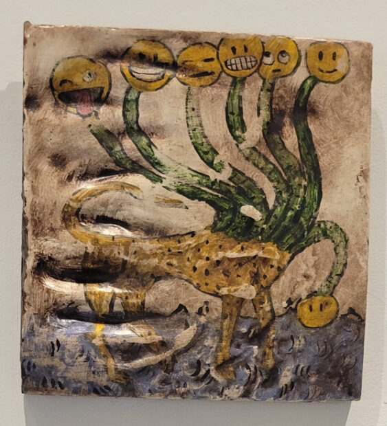 Painting of a hydra with emoji faces on plaster
