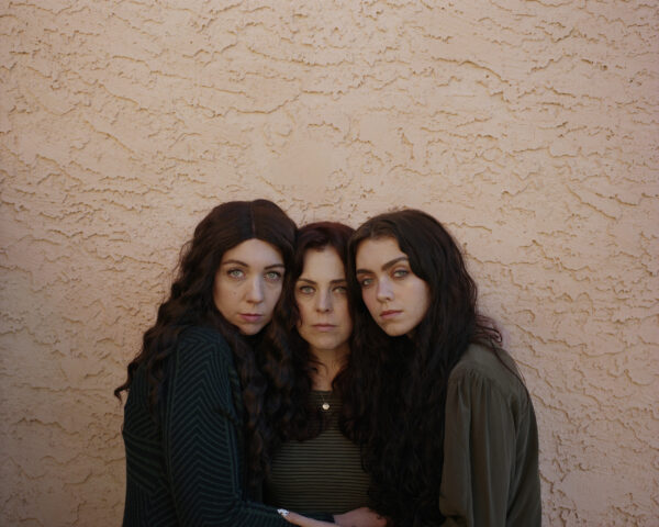 Photo of three sisters hugging each other
