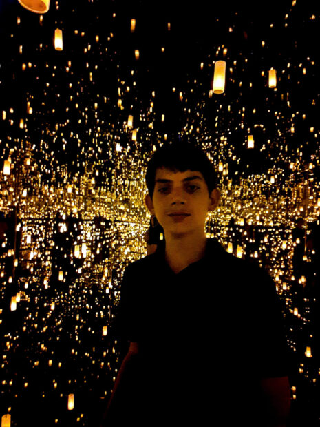8th grade student standing in an infinity room by Kusama