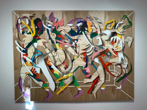 A chaotic, colorful painting of figures on wood.