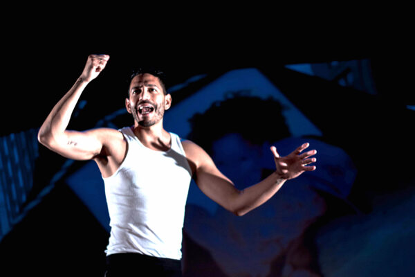 A photograph of performer Christopher Rivas in the production "The Real James Bond... Was Dominican."