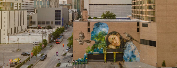 A large-scale mural by Emily Ding on the side of a building in downtown Houston.