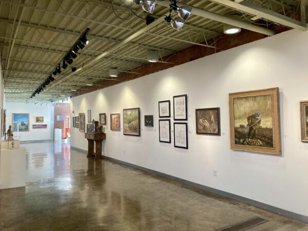 Installation view of works hanging on a white wall in a gallery space