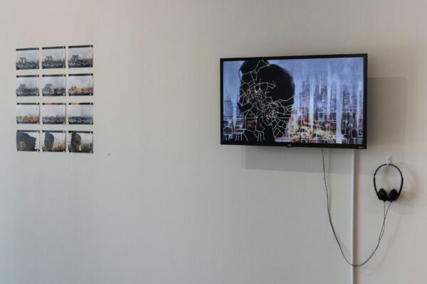 Installation view of a flatscreen monitor and video stills in a grid