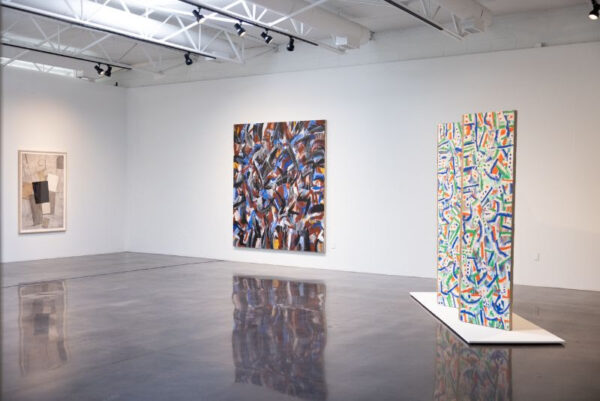 An installation image of large collage works on view at Barry Whistler Gallery in Dallas.