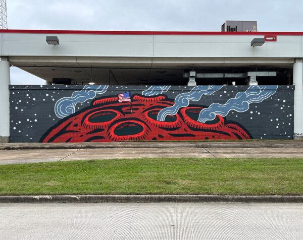A mural painted by artist Kill Joy on the outside of a bus facility.