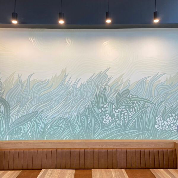 A photograph of a mural by Kill Joy on an interior wall. The mural depicts a stylized painting of tall grass blowing in the wind.