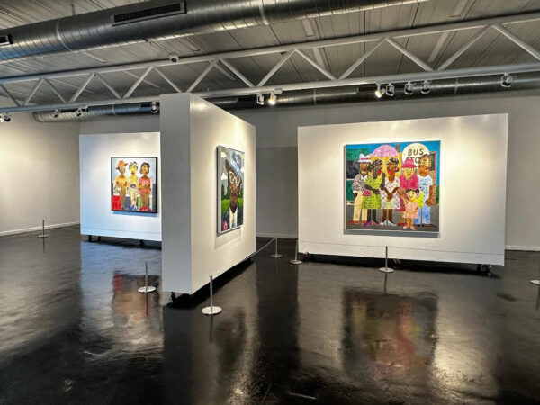 Installation view of figurative paintings on white walls