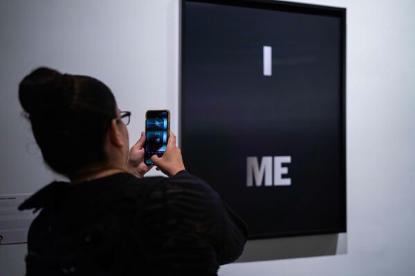 Photo of a museum visitor taking a photo of a piece