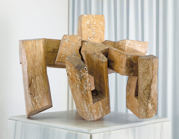 A large abstract wooden sculpture by Eduardo Chillida.