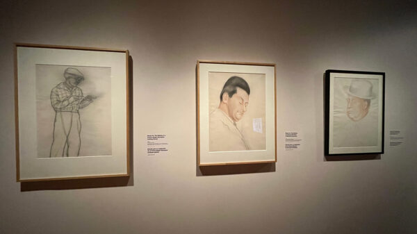 An installation photo of three framed drawings that served as studies for a large-scale mural by Diego Rivera.