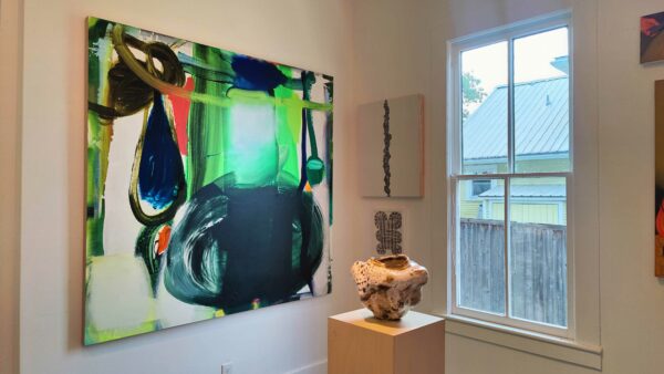 Two dimensional works and a sculpture in a gallery