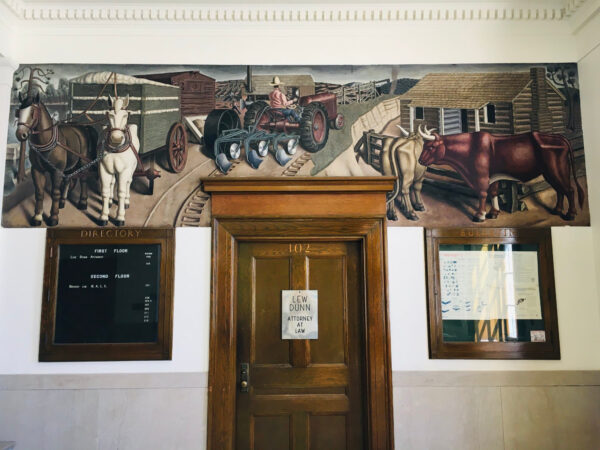 Mural of cattle above the door of a post office