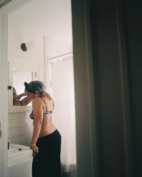 Photo of a woman looking in the mirror