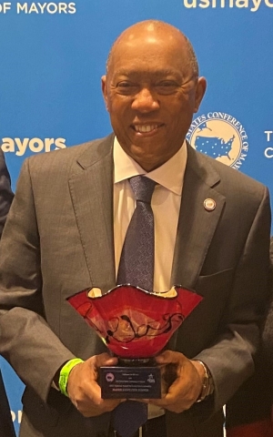 A photograph of Houston Mayor Sylvester Turner holding an award.