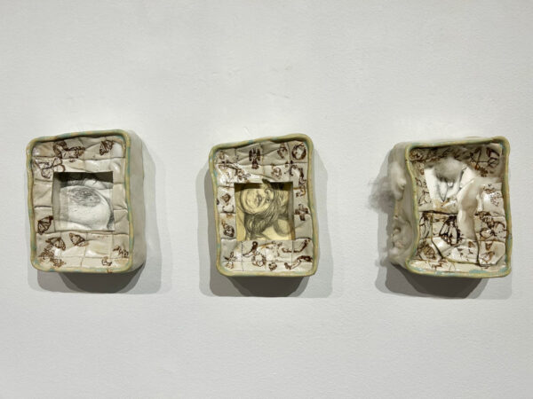 Three square porcelain works on a wall