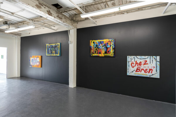 Installation view of paintings on a black wall