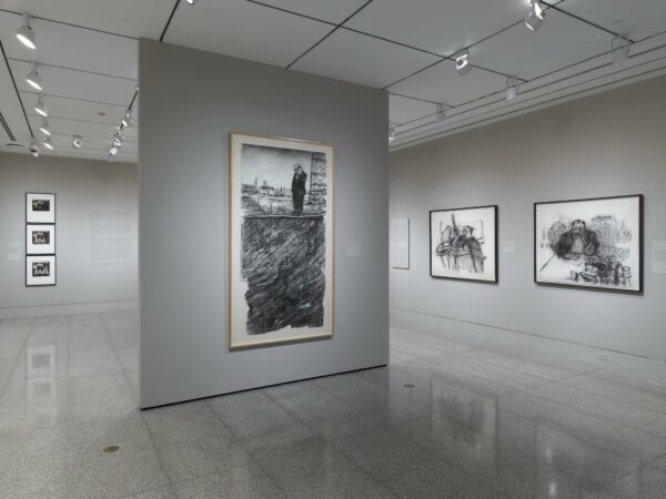 An installation image of large charcoal drawings by William Kentridge.