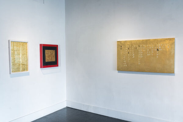 Installation view of works in gold leaf on a white wall