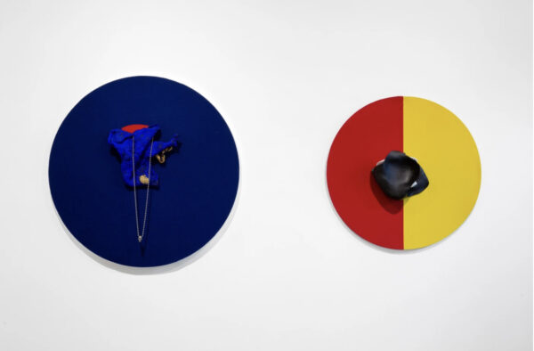 Circular paintings a blue on the left and a yellow and red on the right