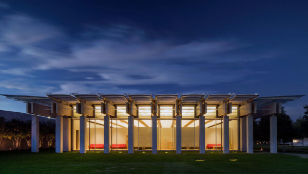 A night time photograph of the exterior of the Renzo Piano Pavilion at the Kimbell Art Museum.