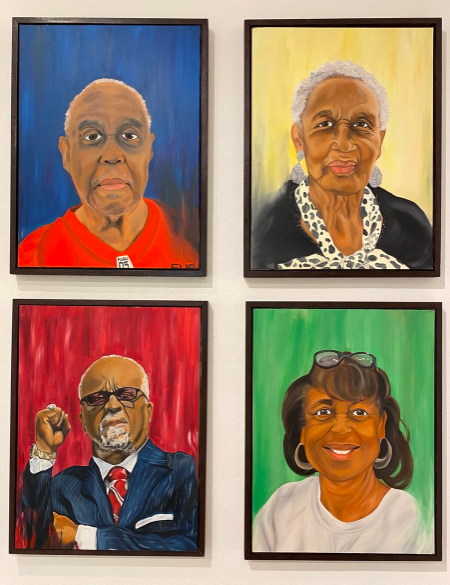 A photograph of four painted portraits of Black leaders by Lillian Young.